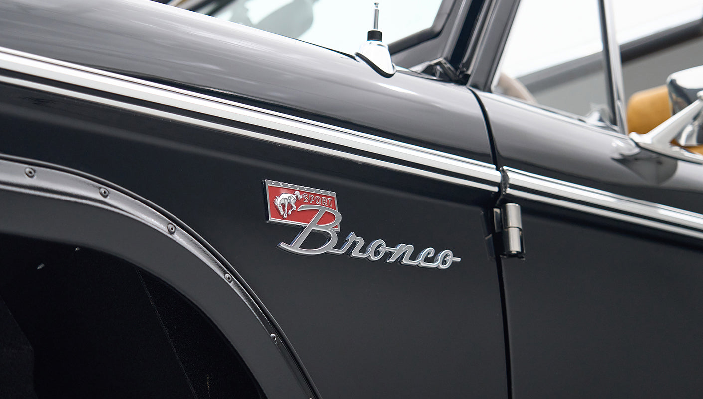 Close-up of black Classic Ford Bronco badge and side panel with trim