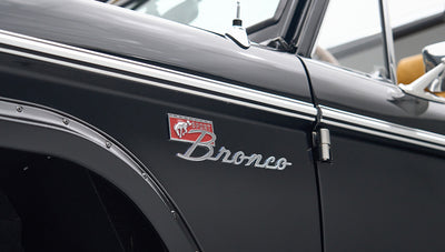 Close-up of black Classic Ford Bronco badge and side panel with trim