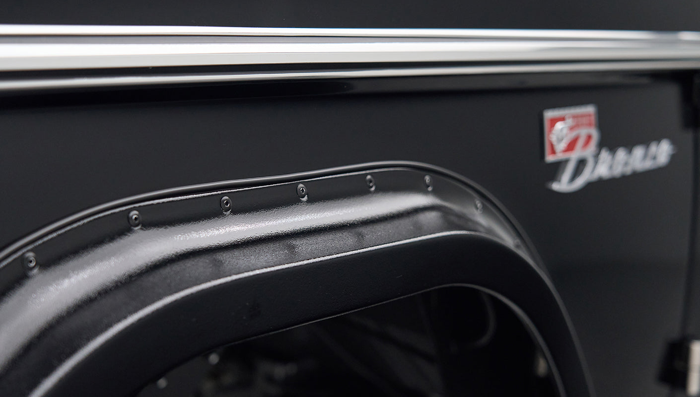 Detailed view of black Classic Ford Bronco fender flare and part of badge