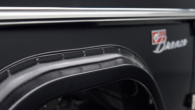 Detailed view of black Classic Ford Bronco fender flare and part of badge