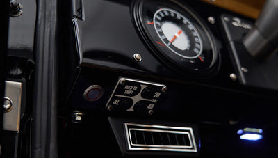 Close-up of Classic Ford Bronco dashboard focusing on gauges and 4x4 shift control