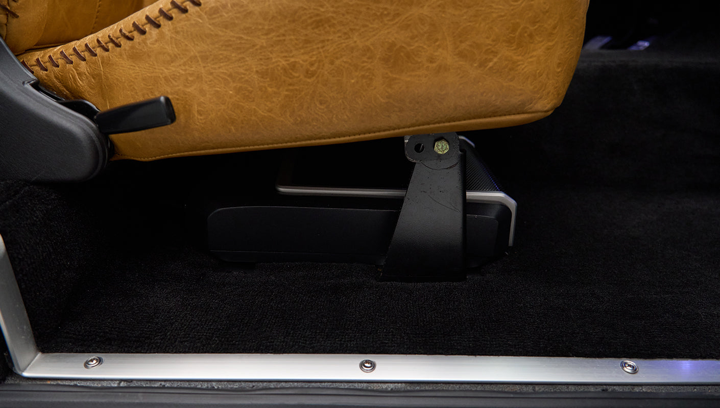 Close-up of tan leather seat with black seat mount inside Classic Ford Bronco