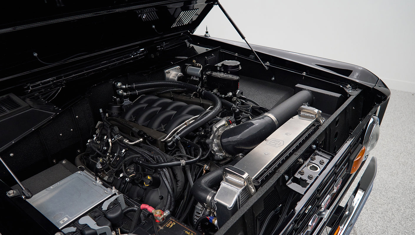 Engine compartment of Classic Ford Bronco showing engine, radiator, and surrounding components