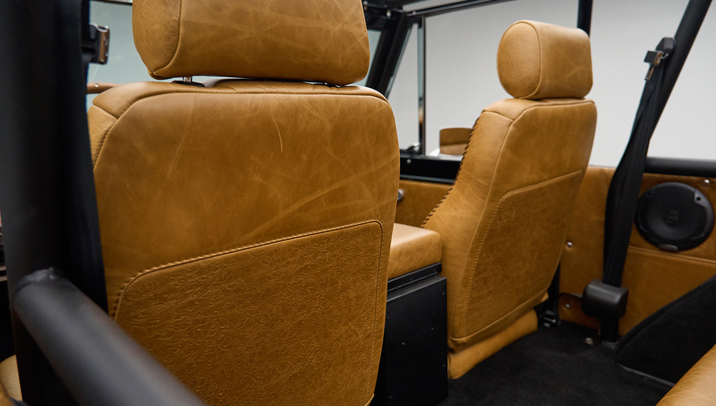 Side interior view focusing on rear seats and roll cage inside Classic Ford Bronco