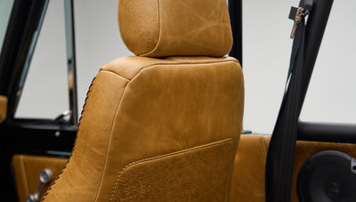 Close-up of tan leather driver's seat back with embossed floral pattern in Classic Ford Bronco