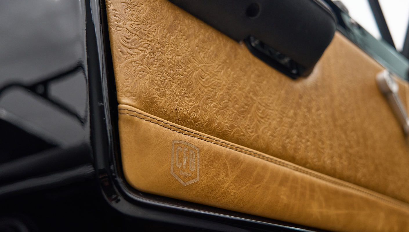 Close-up of tan leather door panel with embossed floral design and CFR Series logo