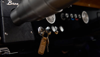 Ignition area with vintage key fob hanging on key in Classic Ford Bronco dashboard