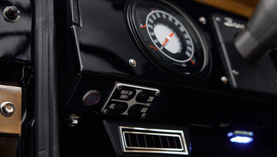 Close-up of Classic Ford Bronco dashboard showing black panel, speedometer, and 4WD control buttons