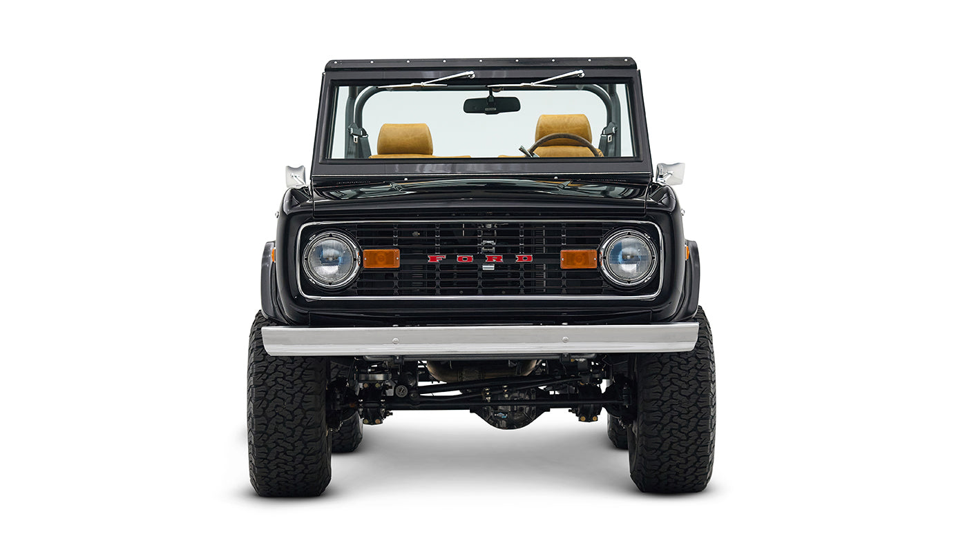 Front view of black Classic Ford Bronco with lifted suspension and chrome wheels