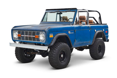 Three-quarter front view of Classic Ford Bronco with lifted suspension and blue patina paint