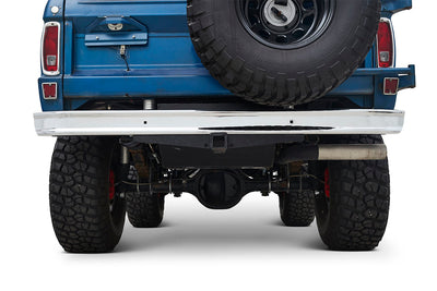 Rear view of a blue Classic Ford Bronco showing spare tire on the back and rugged tires underneath