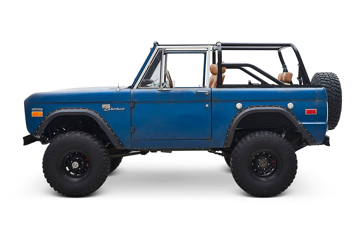 Side view of Classic Ford Bronco with open top and blue patina paint