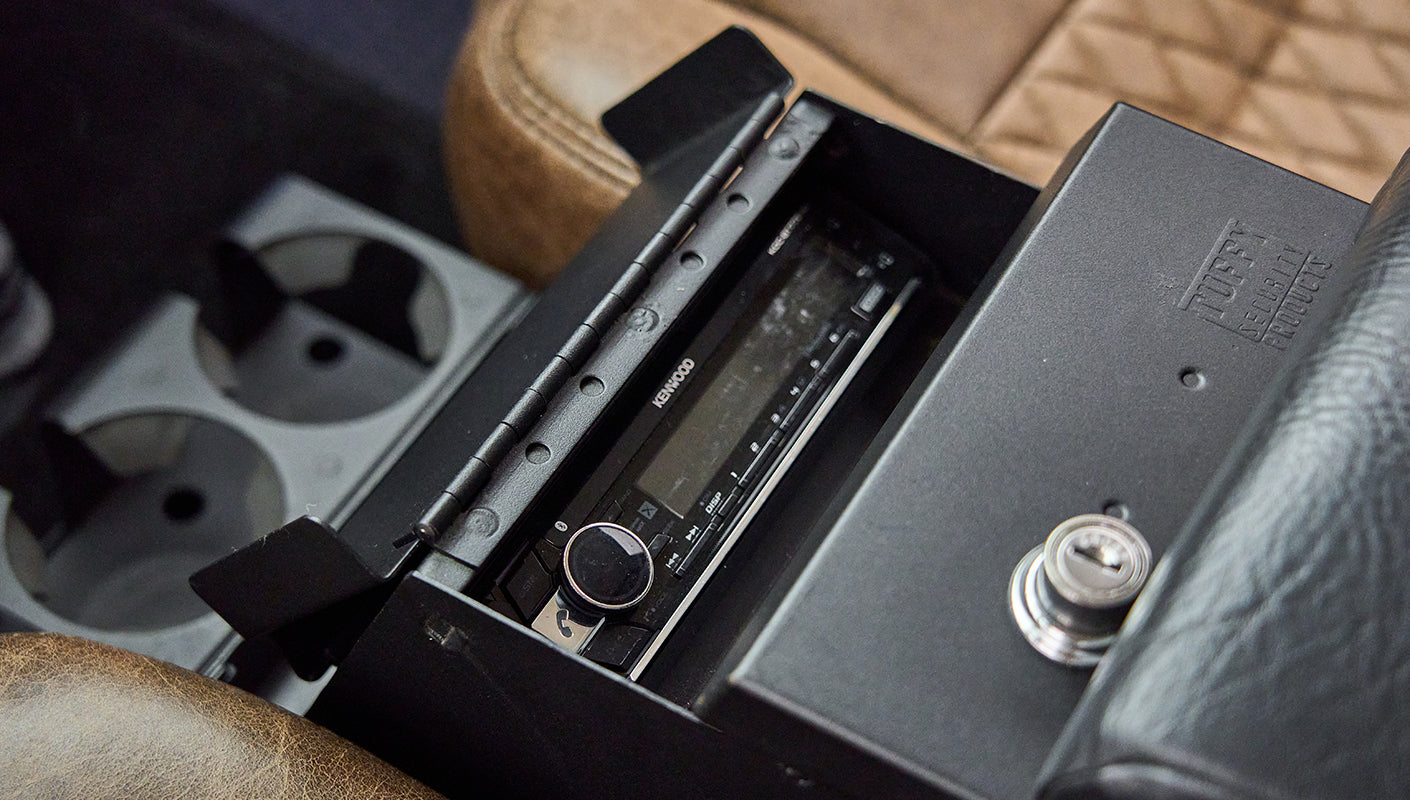 Kenwood car stereo inside the center console of Classic Ford Bronco with brown leather seats