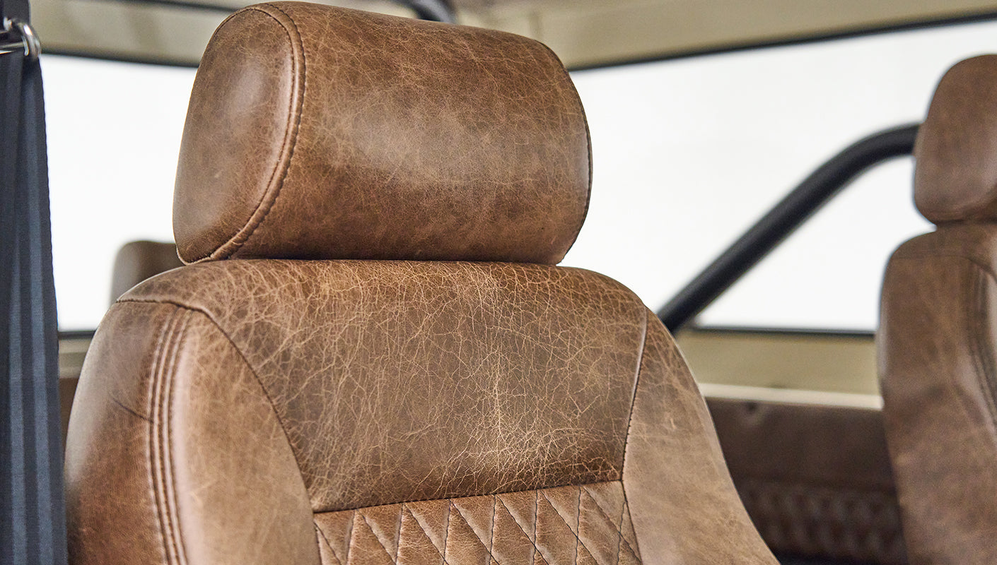 Brown leather headrest and seat inside Classic Ford Bronco interior