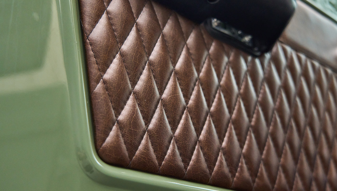 Diamond-stitched brown leather upholstery on Classic Ford Bronco door interior