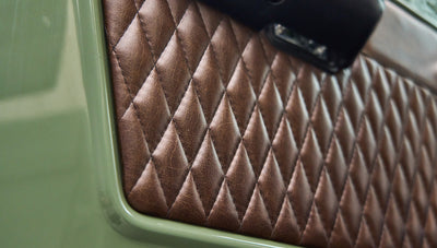 Diamond-stitched brown leather upholstery on Classic Ford Bronco door interior