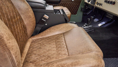 Close-up of textured brown leather seat and center console in Classic Ford Bronco