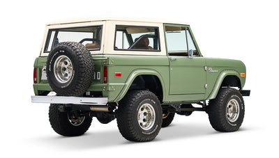 Classic Ford Bronco in boxwood green with white roof, angled rear-side view isolated on white.