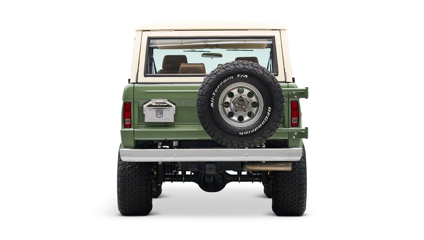 Classic Ford Bronco in boxwood green with white roof, rear profile centered on white background.