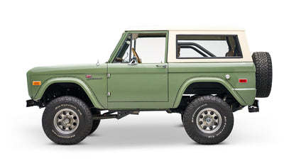 Classic Ford Bronco in boxwood green with white roof, side profile on a white background.