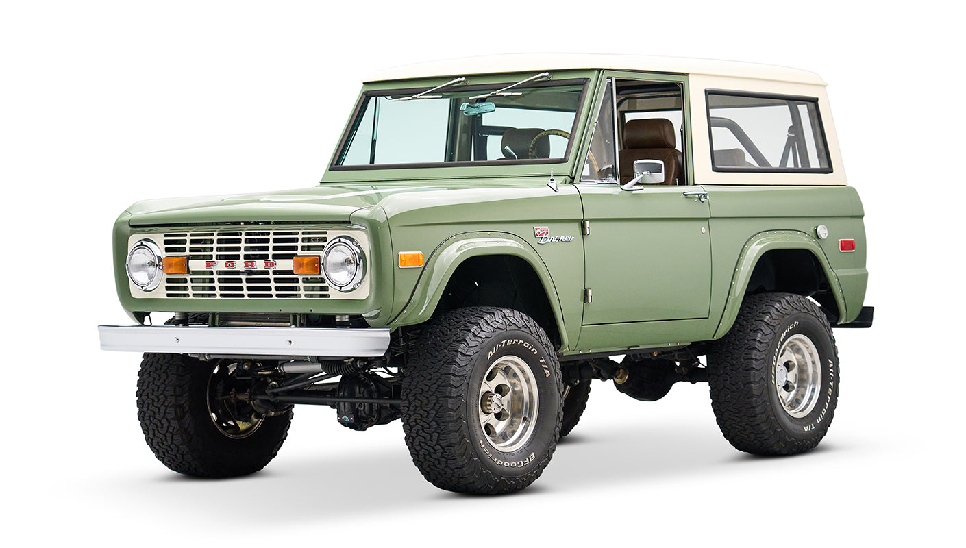 Classic Ford Bronco in boxwood green with white roof shown from front side angle