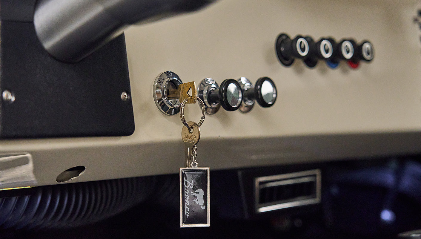 Dashboard with ignition switch and a Ford Bronco keychain hanging in Classic Ford Bronco interior