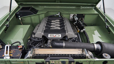 Close-up of 5.0 liter Ford engine and components inside green engine bay of Classic Ford Bronco