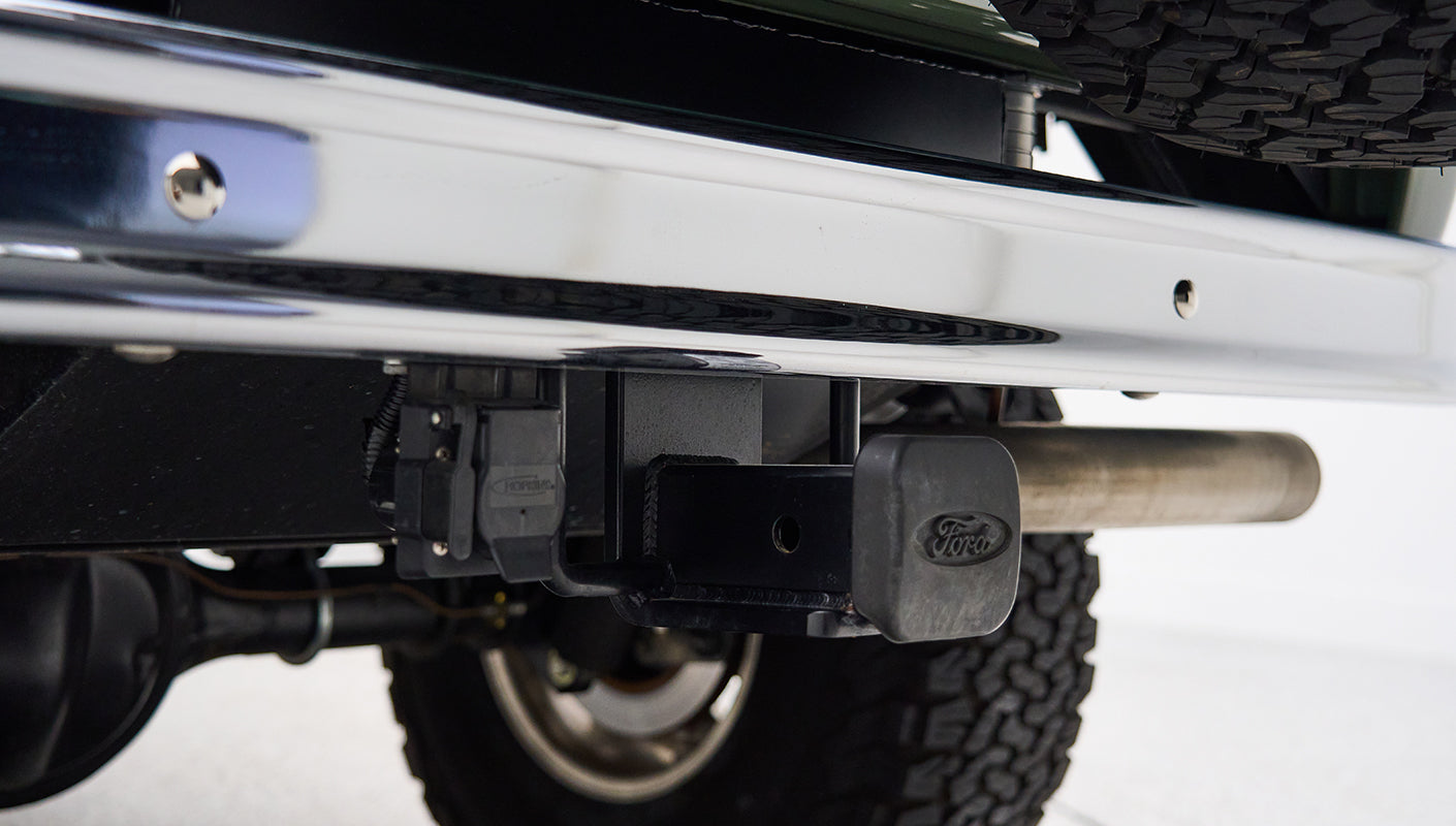 Rear bumper with tow hitch and Ford-branded hitch cover on Classic Ford Bronco