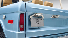 Close-up of Classic Ford Bronco rear corner with license plate frame and tail light in light blue