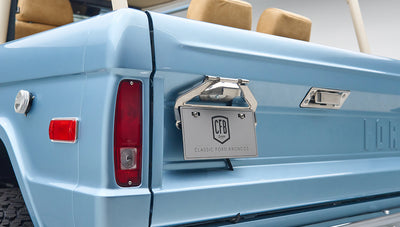 Close-up of Classic Ford Bronco rear corner with license plate frame and tail light in light blue