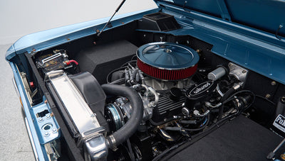 Close-up view of a Classic Ford Bronco engine with visible hoses, air filter, and radiator