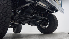Undercarriage view of Classic Ford Bronco front suspension and large all-terrain tires