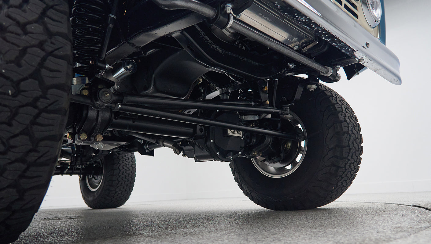 Undercarriage view of Classic Ford Bronco front suspension and large all-terrain tires