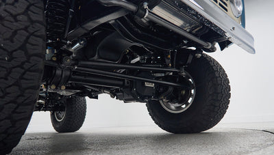 Undercarriage view of Classic Ford Bronco front suspension and large all-terrain tires