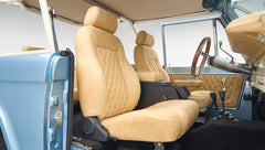Beige leather front seats and interior view of Classic Ford Bronco with open driver door