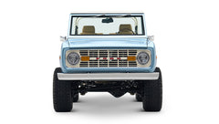 Front view of light blue Classic Ford Bronco with round headlights and FORD grille