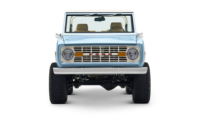Front view of light blue Classic Ford Bronco with round headlights and FORD grille