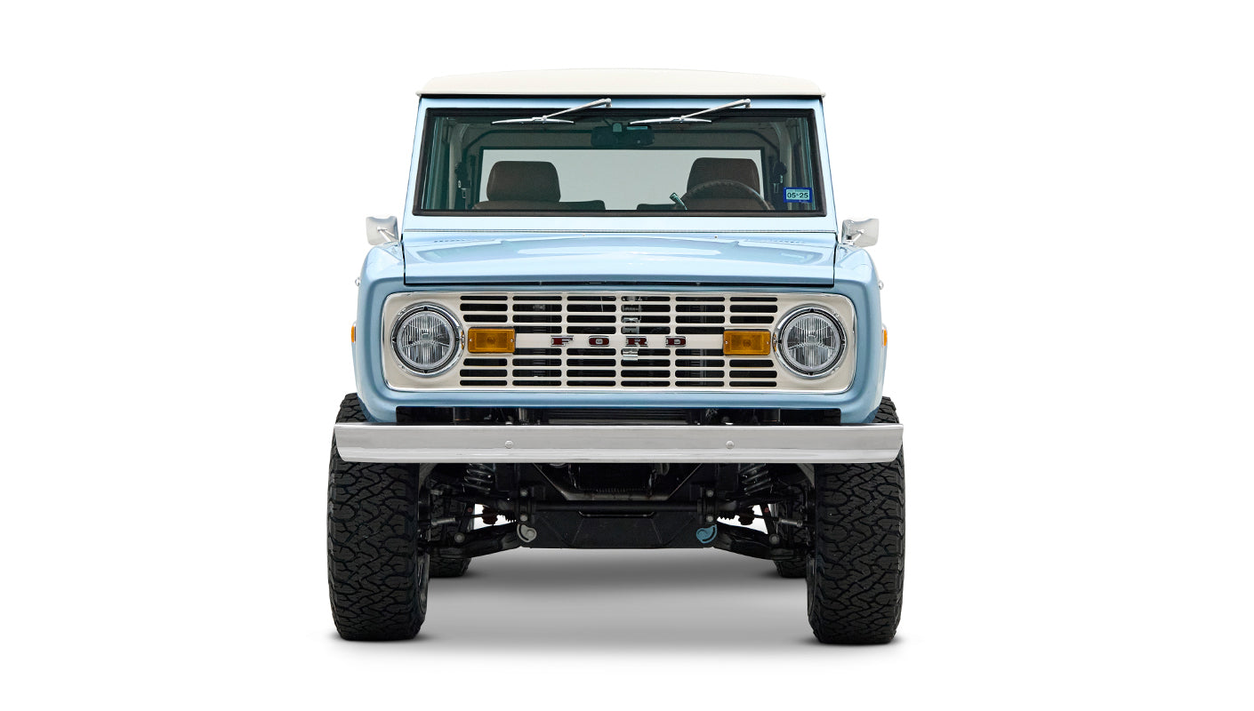 Front view of Classic Ford Bronco Brittany Blue with white hardtop and chrome front bumper