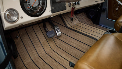 Floor area featuring pedals and brown striped floor mats in Classic Ford Bronco interior