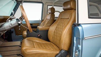 Side view of brown diamond-stitched leather front seats inside Classic Ford Bronco