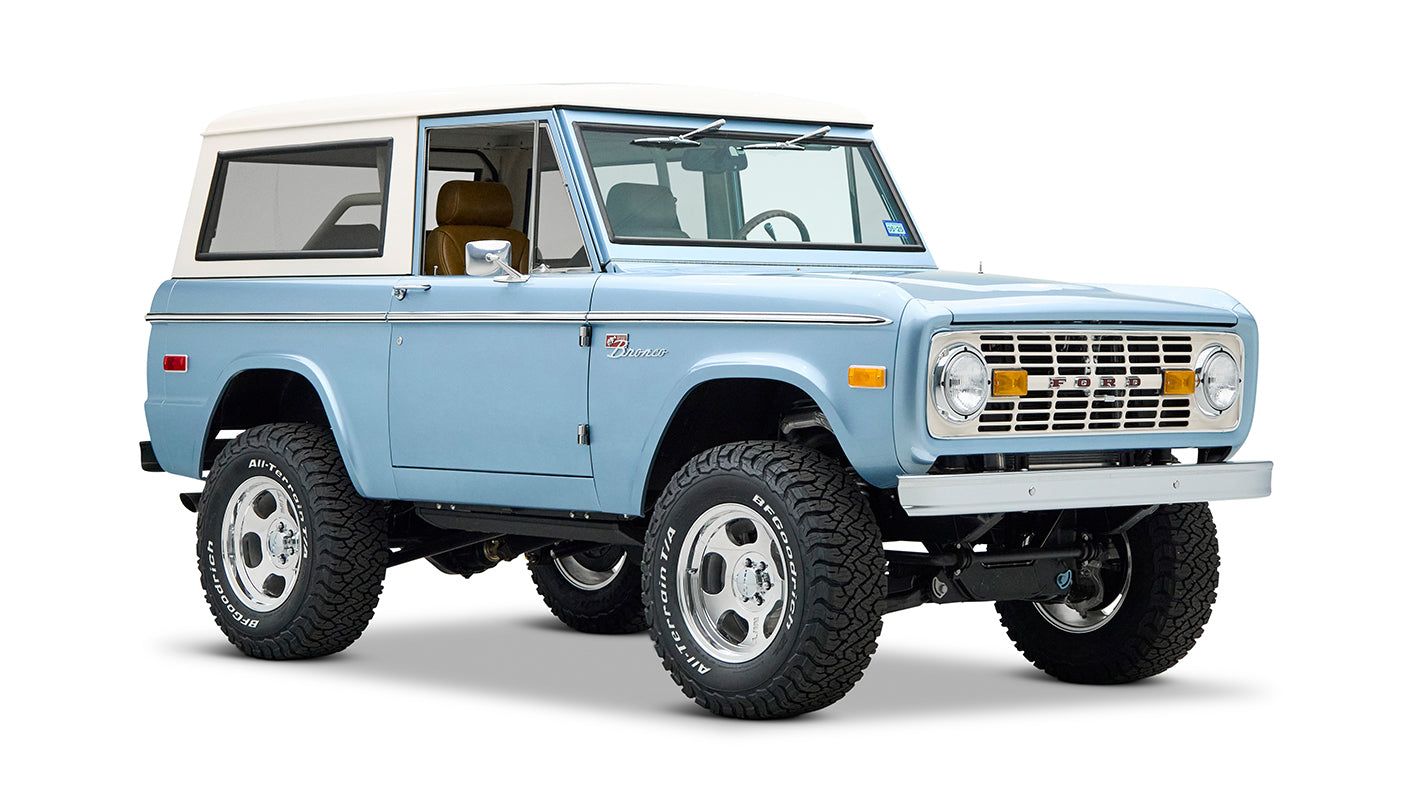 Classic Ford Bronco Brittany Blue front view showing headlights, grille, and lifted tires