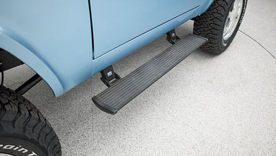 Blue vehicle exterior with extended black side step and large off-road tire