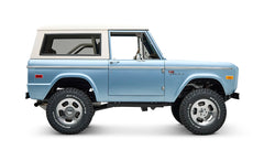 Side profile of Classic Ford Bronco Brittany Blue with white hardtop and BFGoodrich tires