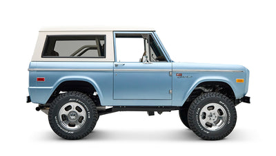 Side profile of Classic Ford Bronco Brittany Blue with white hardtop and BFGoodrich tires
