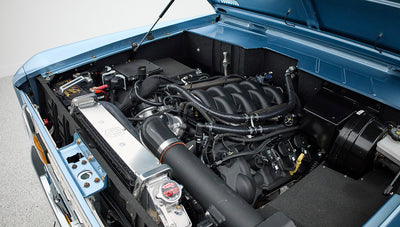 Side view of Classic Ford Bronco engine bay with hood open showing engine details and radiator