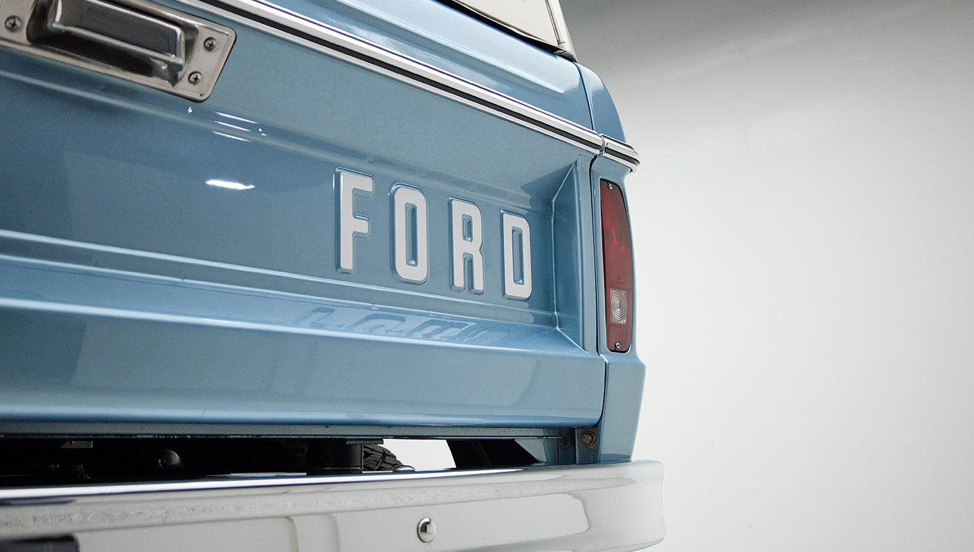 Rear detail of Classic Ford Bronco tailgate with blue paint and white FORD lettering