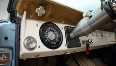 Dashboard view in Classic Ford Bronco featuring vintage speedometer and classic Bronco badge