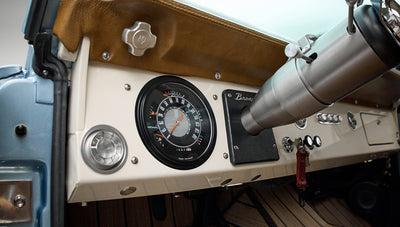 Dashboard view in Classic Ford Bronco featuring vintage speedometer and classic Bronco badge