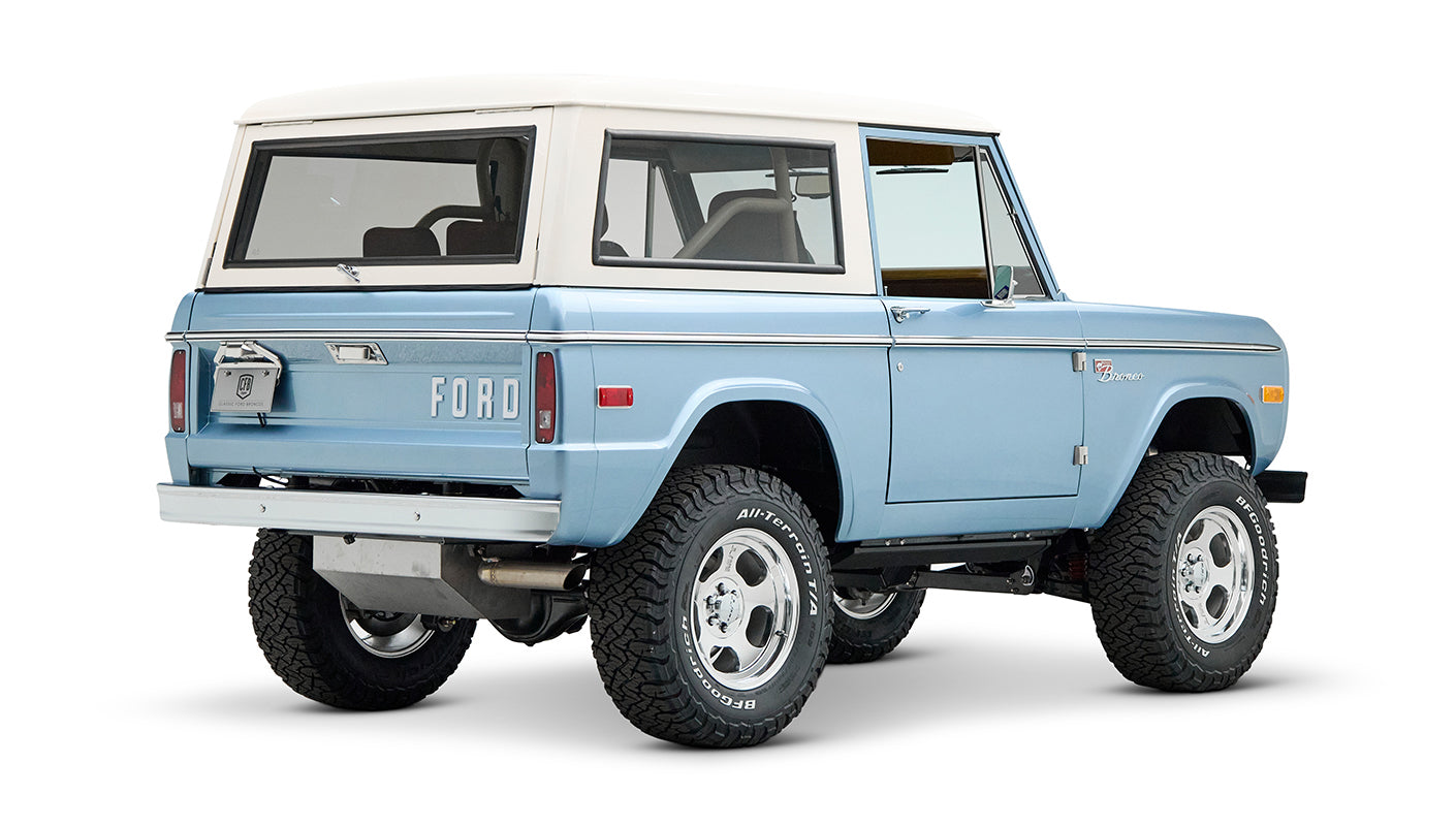 Classic Ford Bronco Brittany Blue with white hardtop viewed from rear side angle