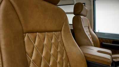 Close-up of brown leather front seats with diamond stitching in Classic Ford Bronco